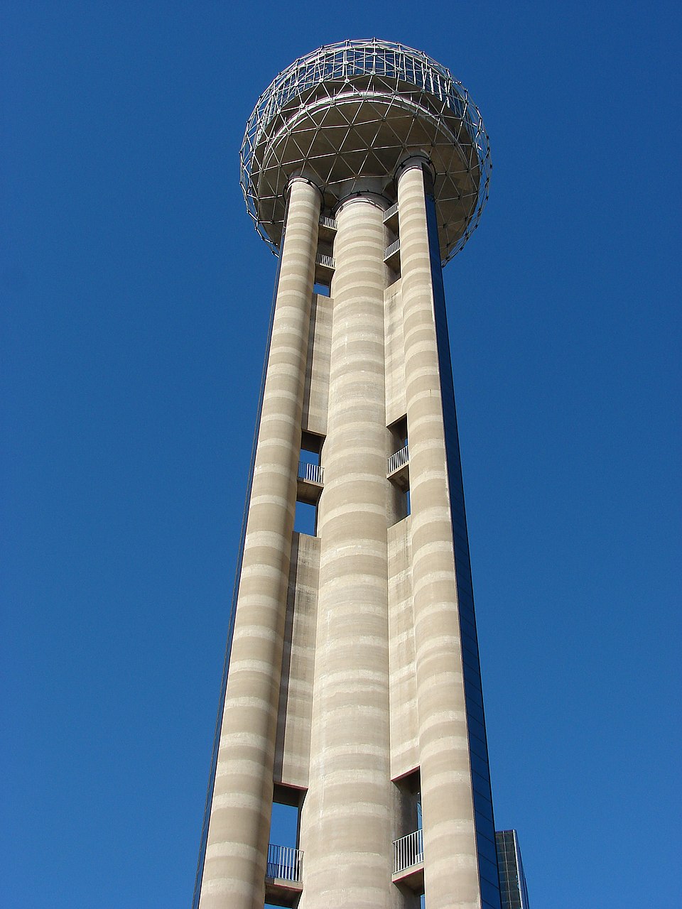 Reunion Tower glowing against the night sky in Dallas